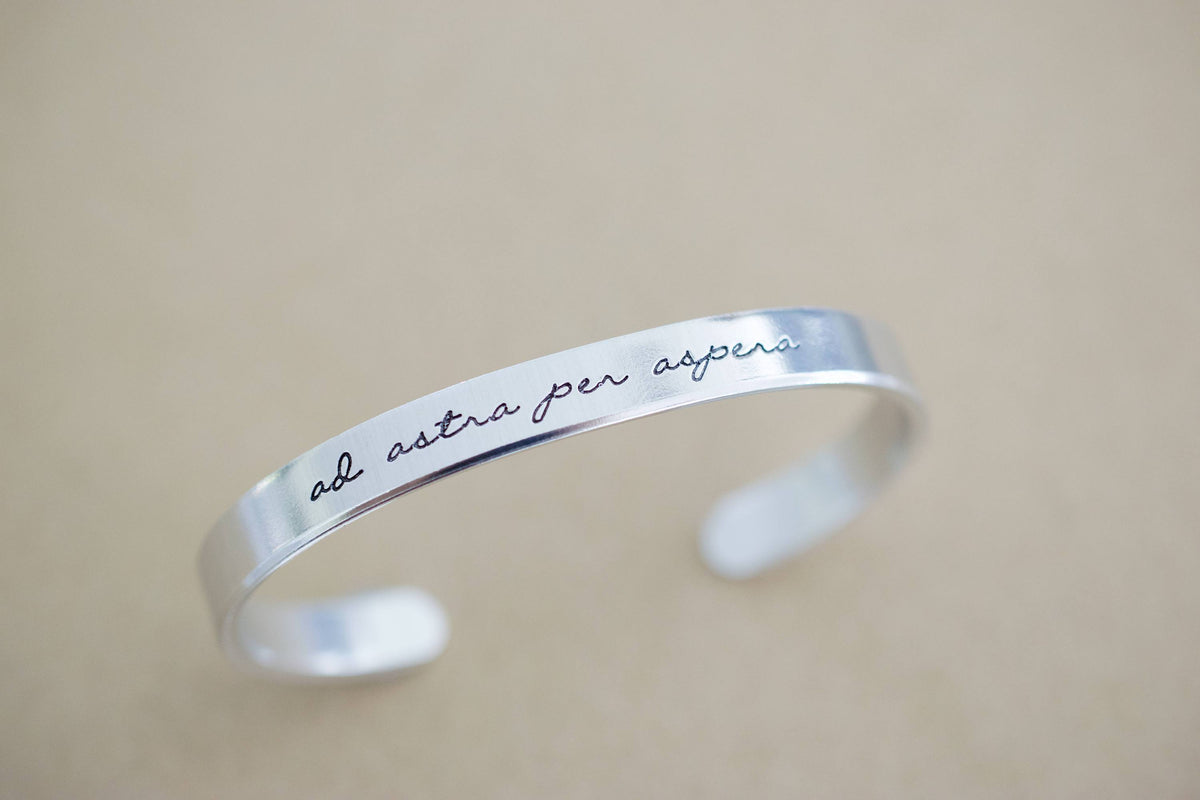 Ad Astra Per Aspera Bracelet | Latin Cuff Bracelet, propped up display