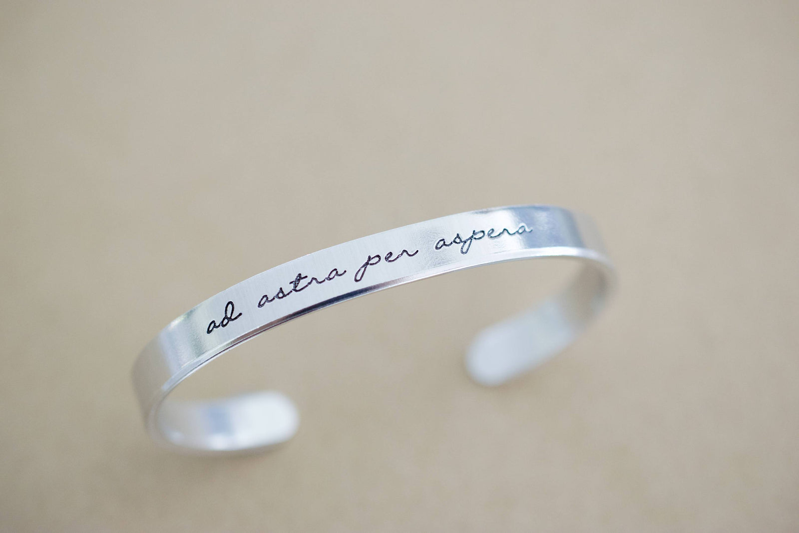 Ad Astra Per Aspera Bracelet | Latin Cuff Bracelet, propped up display