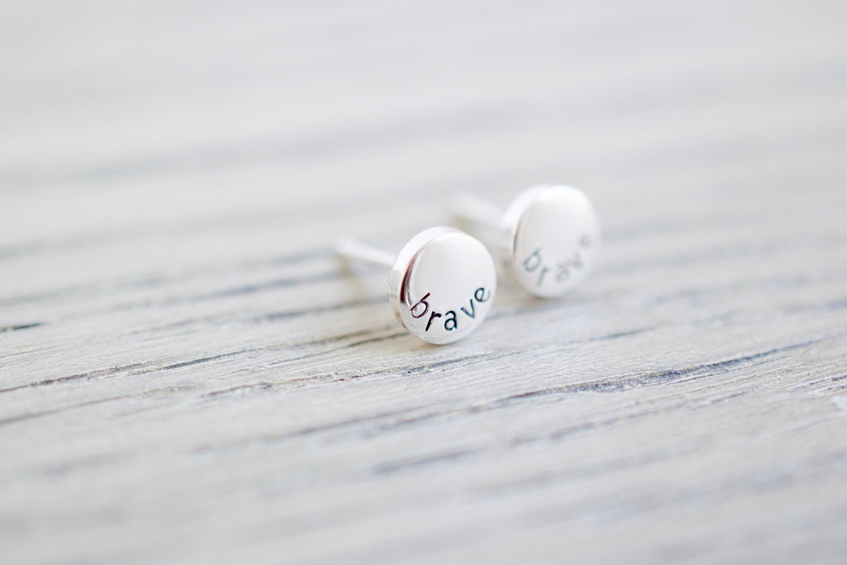 Brave Stud Earrings, wood background