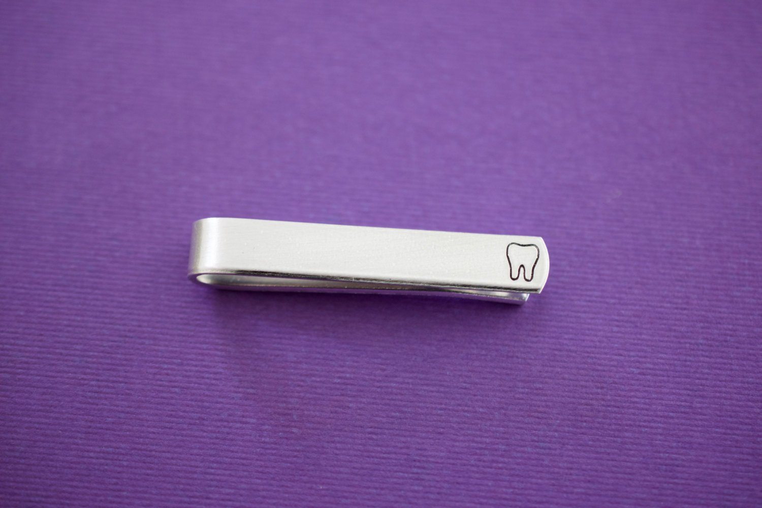 Tooth Tie Bar, purple background